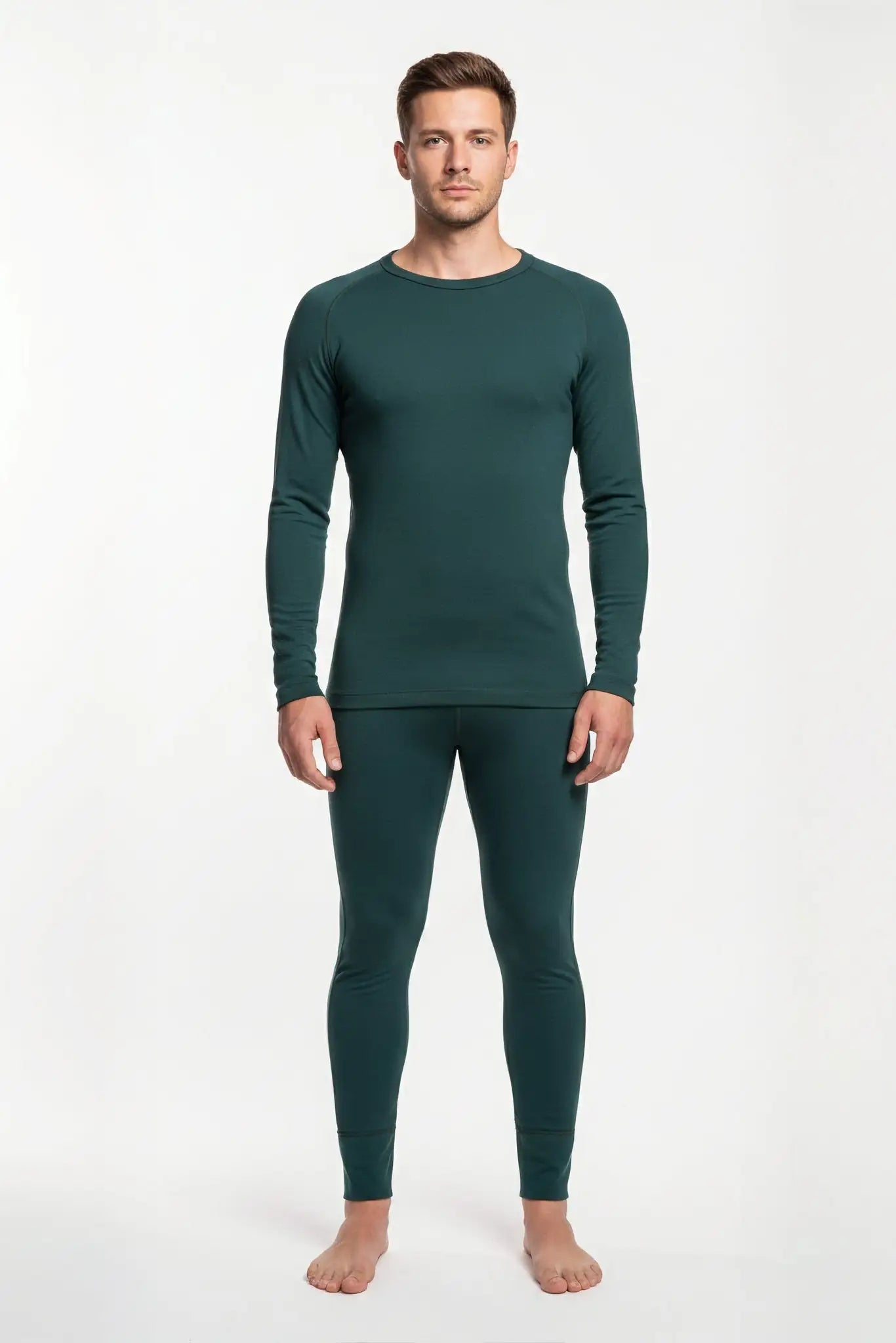 Man wearing a merino wool green thermal outfit on a white background