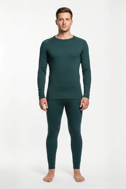 Man wearing a merino wool green thermal outfit on a white background