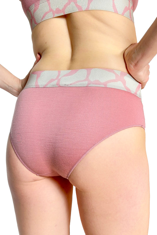 Pink merino underwear with a subtle pattern worn by a person on a white background