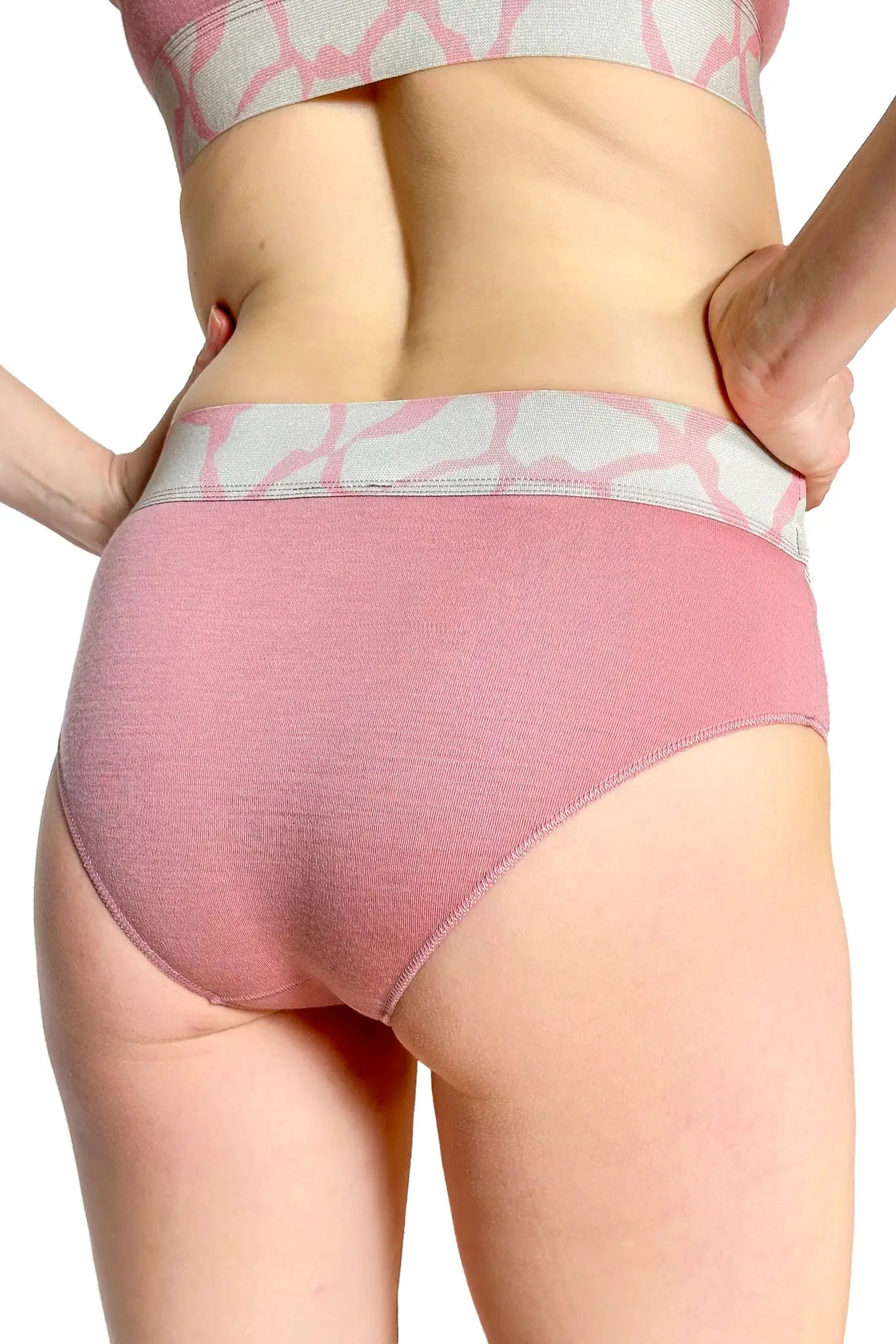 Pink merino underwear with a subtle pattern worn by a person on a white background