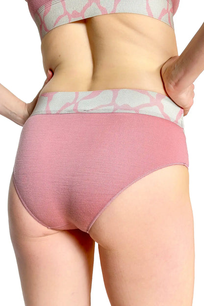 Pink merino underwear with a subtle pattern worn by a person on a white background