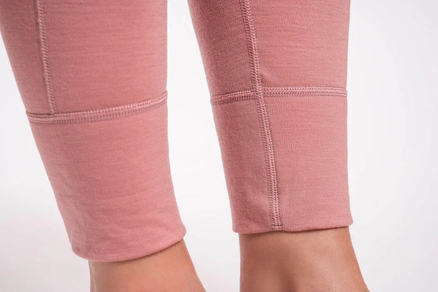 Close-up of pink merino wool leggings on a white background