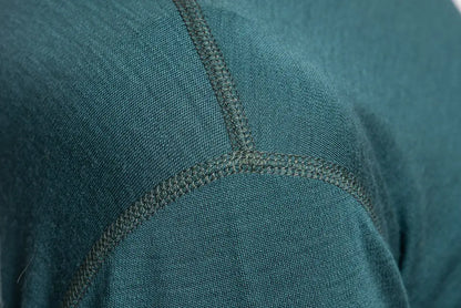 Close-up of teal fabric merino wool with flat lock seam