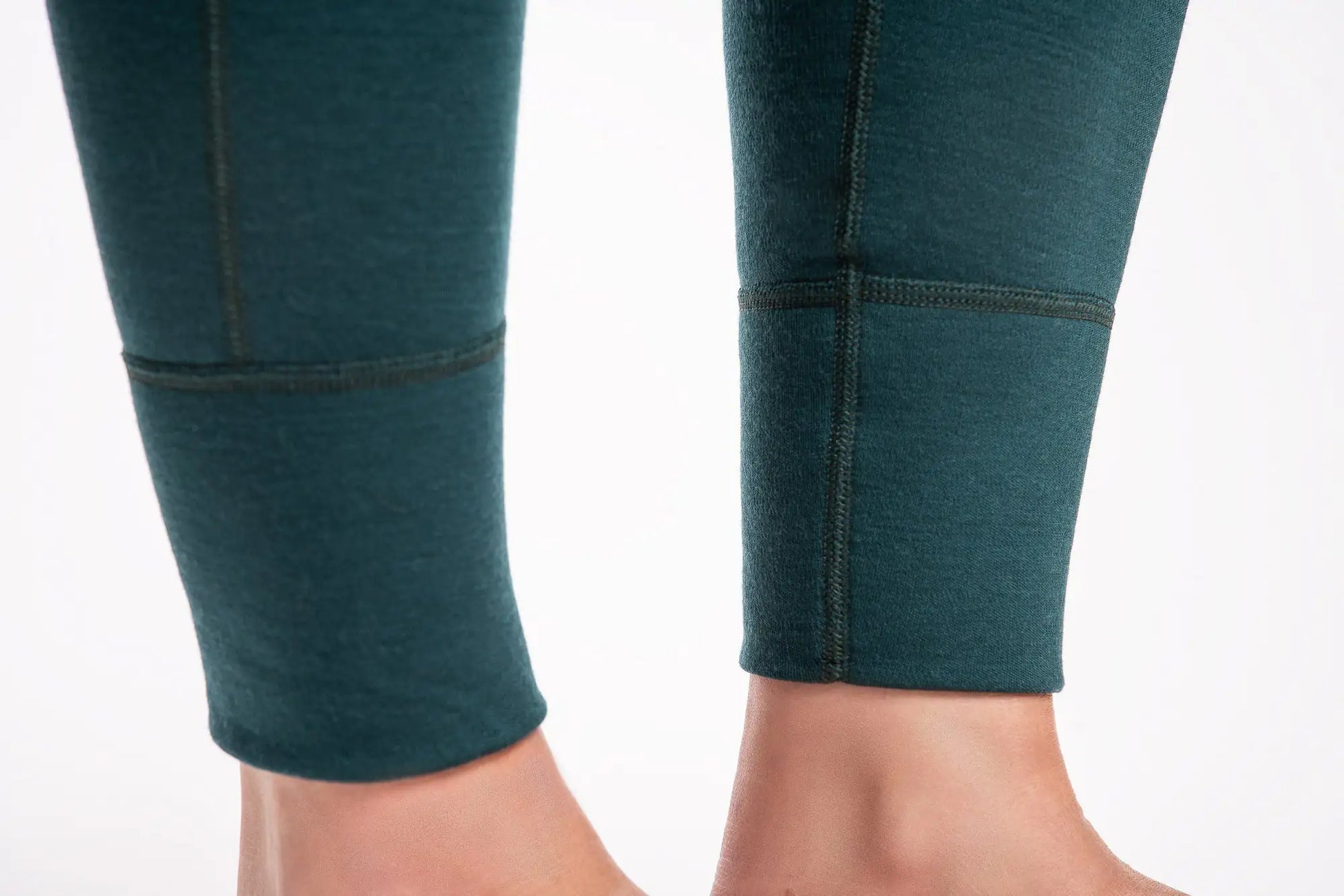 Teal leggings with black accents on a white background