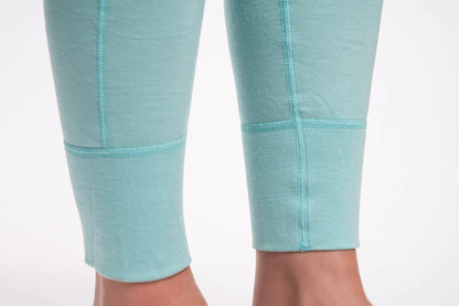 Close-up of teal merino leggings with a white background